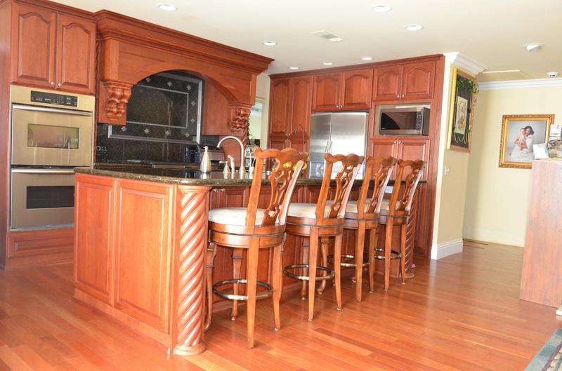 Custom cabinetry photo of California kitchen with furniture grade vent hood